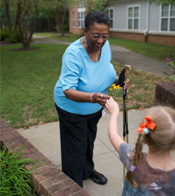 Resident accepts flower from child
