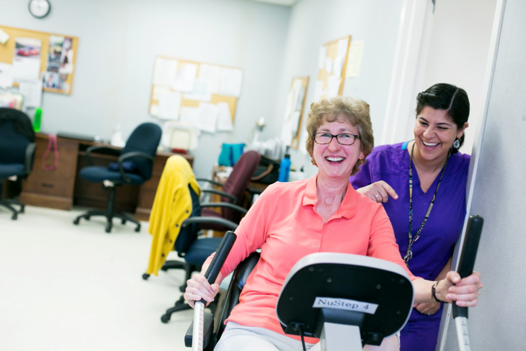 senior learns to use fitness equipment