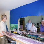 residents work on model trains