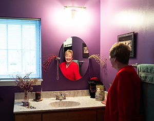 collington-resident-looking-in-bathroom-mirror