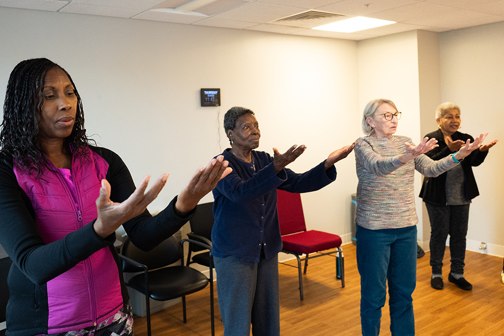 residents practicing tai chi in fitness room
