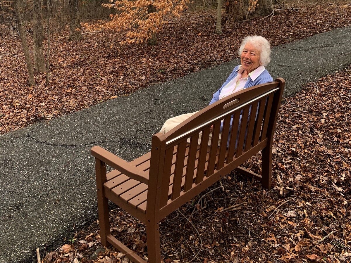 resident sitting on TREX bench
