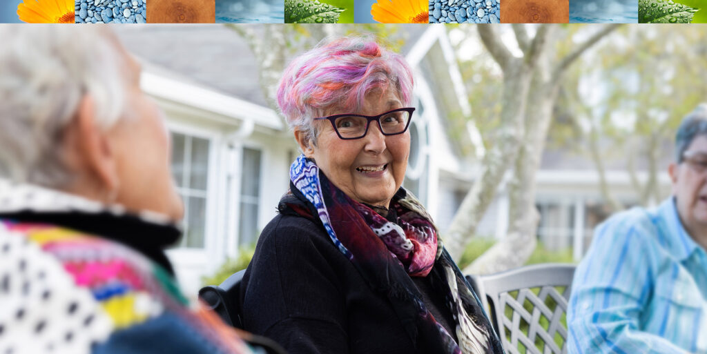 three women seated outside, talking