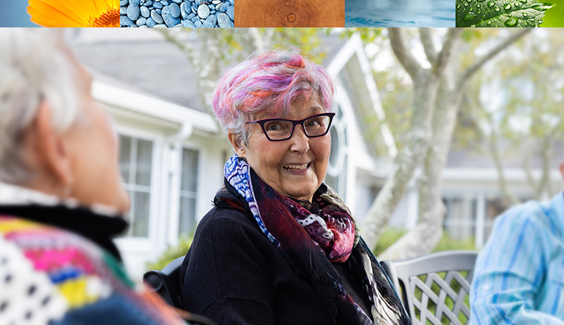 three women seated outside, talking