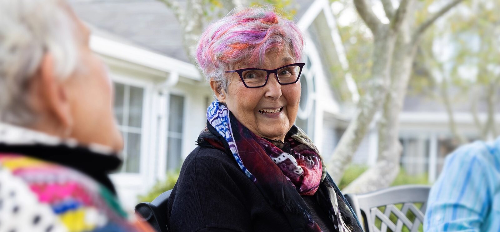 Ladies seated outside under trees